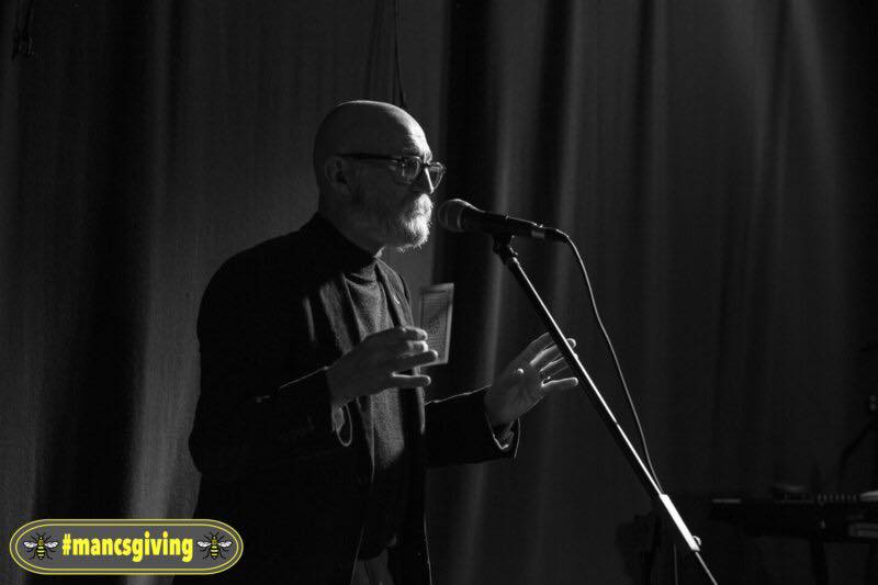 Magician at microphone with predicted card