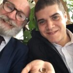 all age magician with boy who has bent a coin