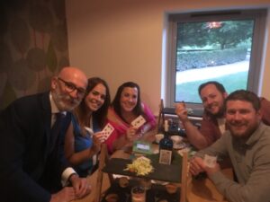 Grou of peole at a table and a magician