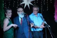 two audience memebrs on stage with a magician