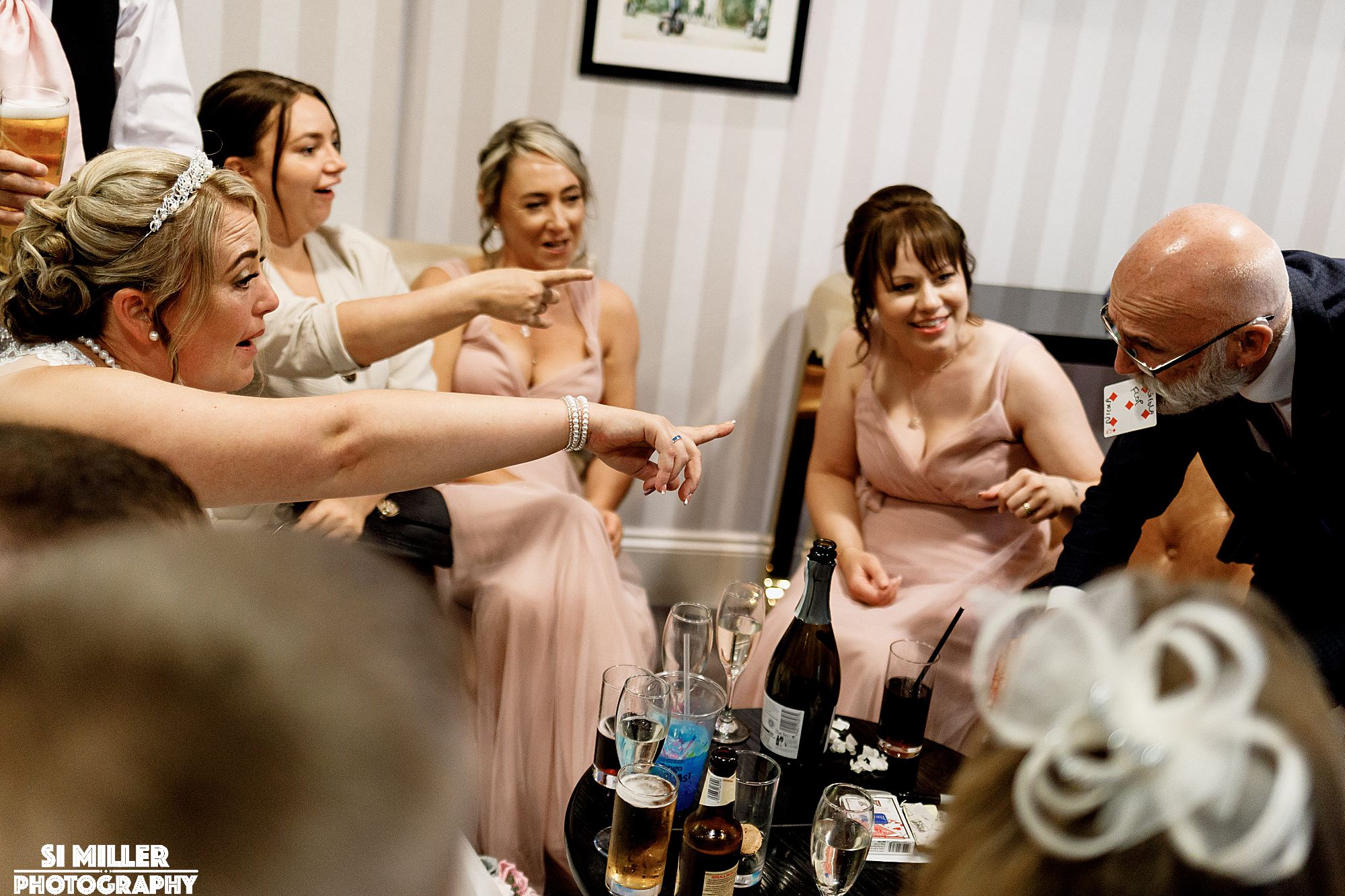 women pointig at magician