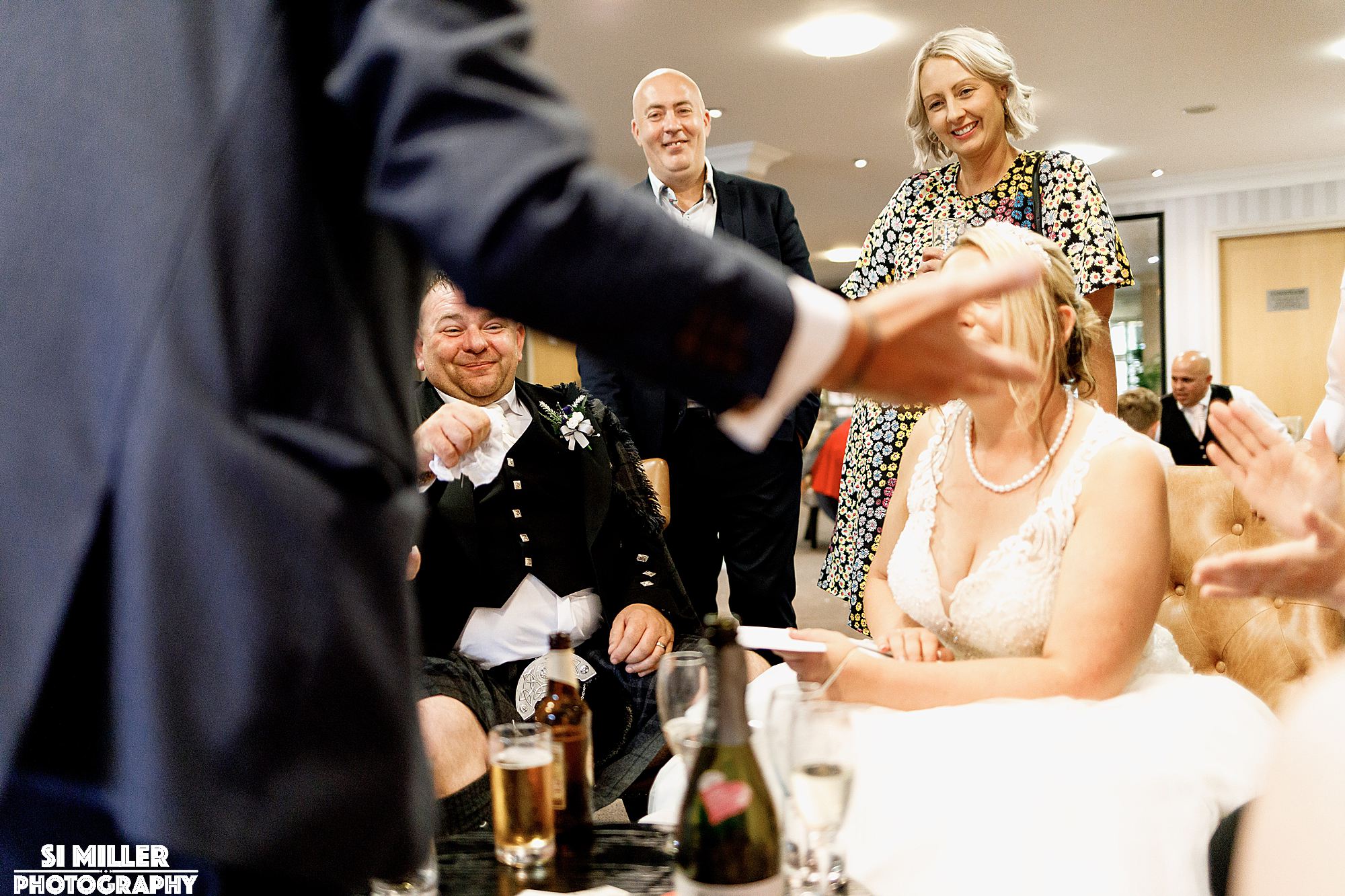 smiling groom in unusual framing.