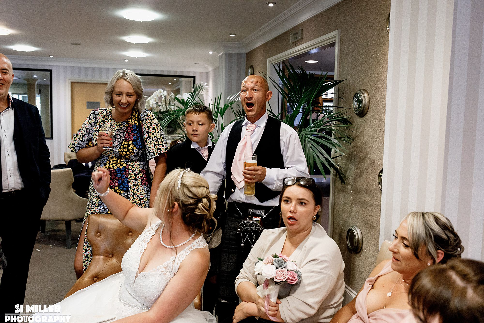 open mouthed guests watching magic show. Great image for a wedding album.