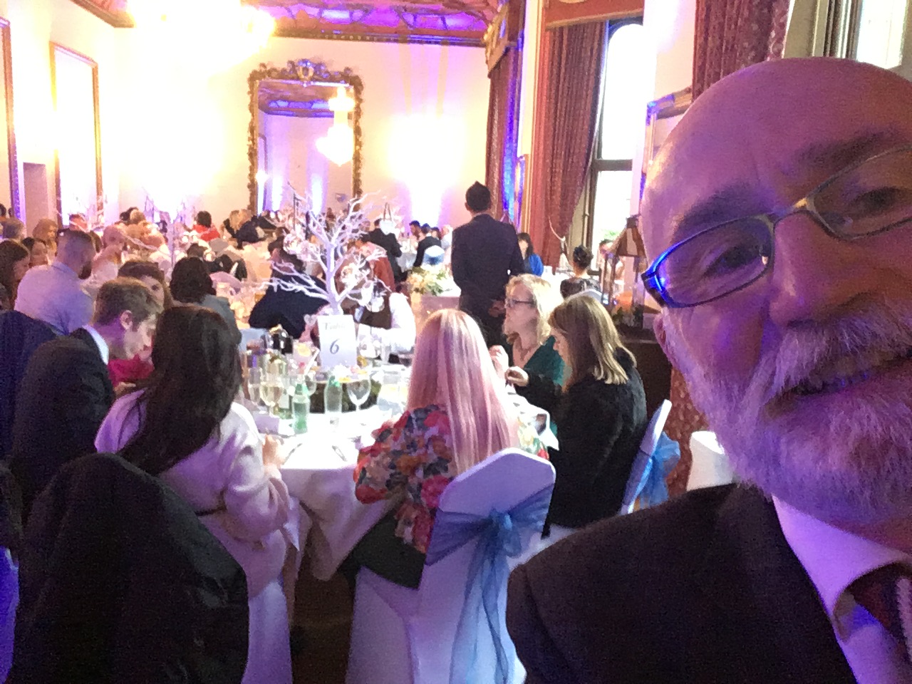 magician wiht wedding reception in the background